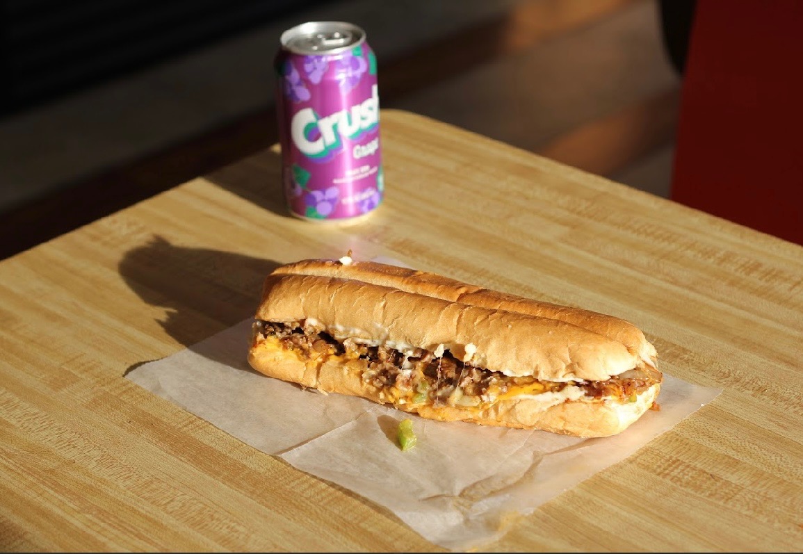 Philly cheese steak sub with grape Crush